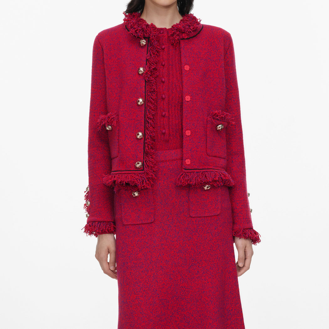 A close up of a woman wearing the Red Frayed Knit Midi Skirt