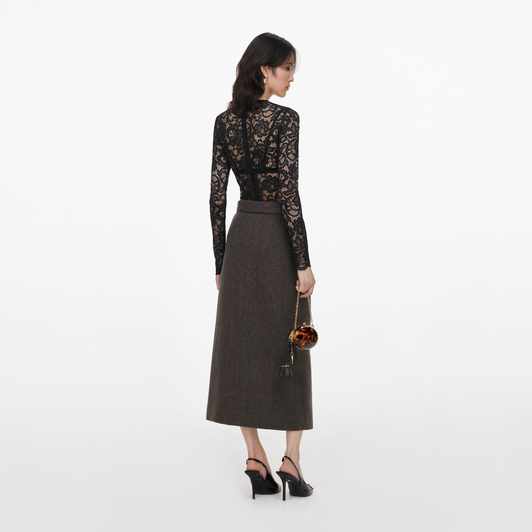 Back view of a woman wearing the Brown Wool Midi Skirt