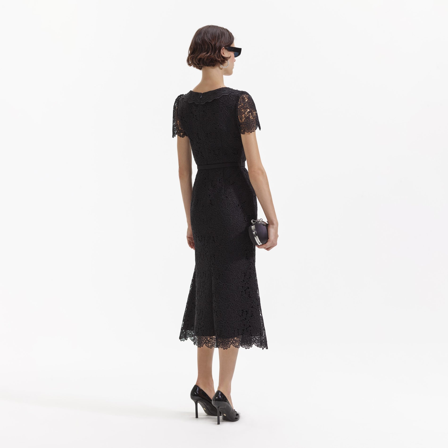 Back view of a woman wearing the Black Guipure Lace Button Midi Dress