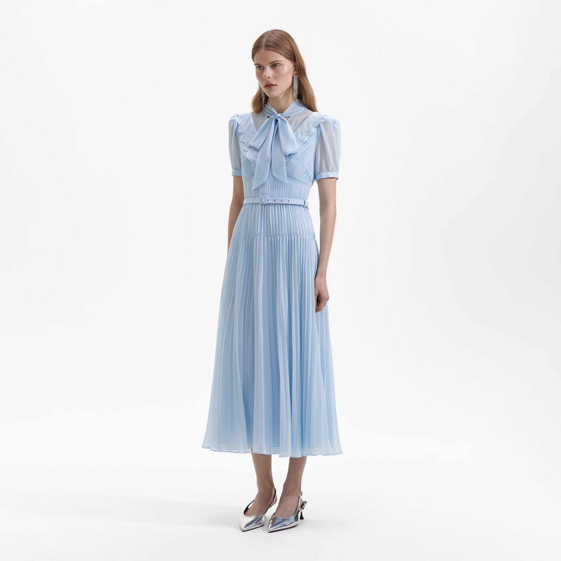 Side view of a woman wearing the Blue Chiffon Bow Midi Dress