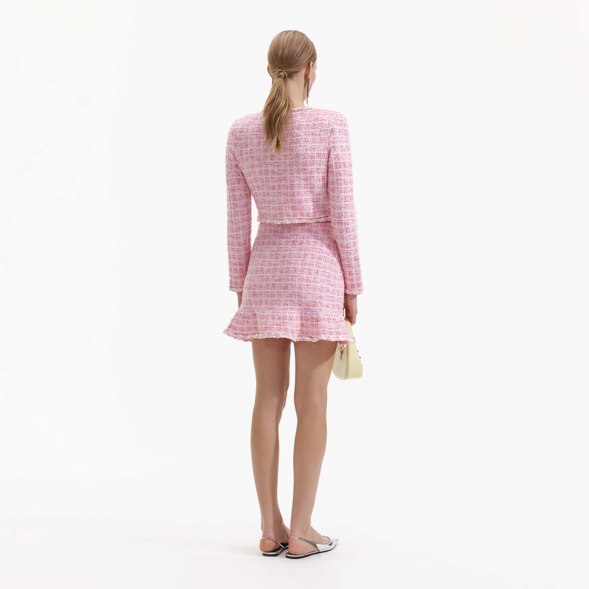 Back view of a woman wearing the Pink Check Knit Cardigan