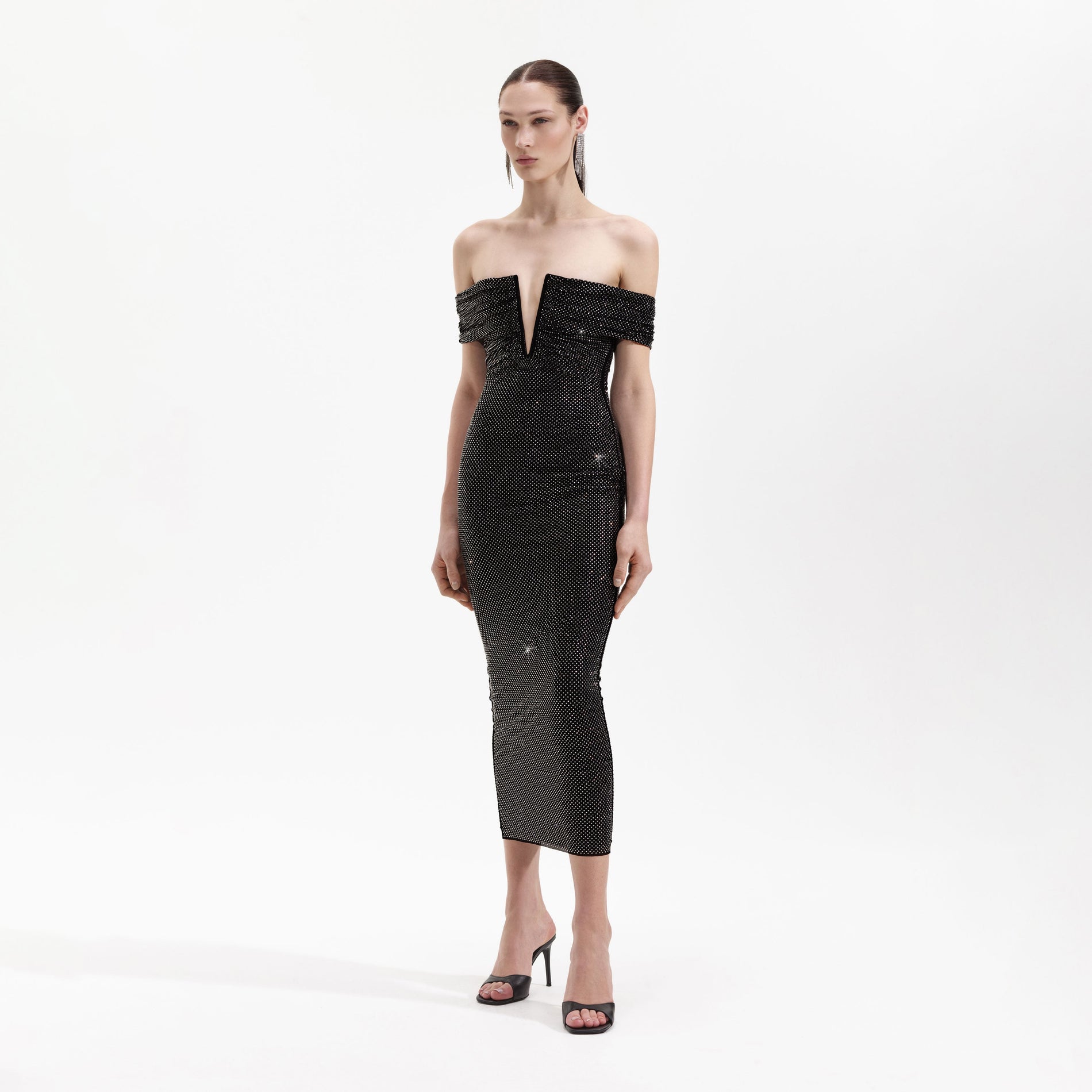 Side view of a woman wearing the Black Rhinestone Bardot Midi Dress