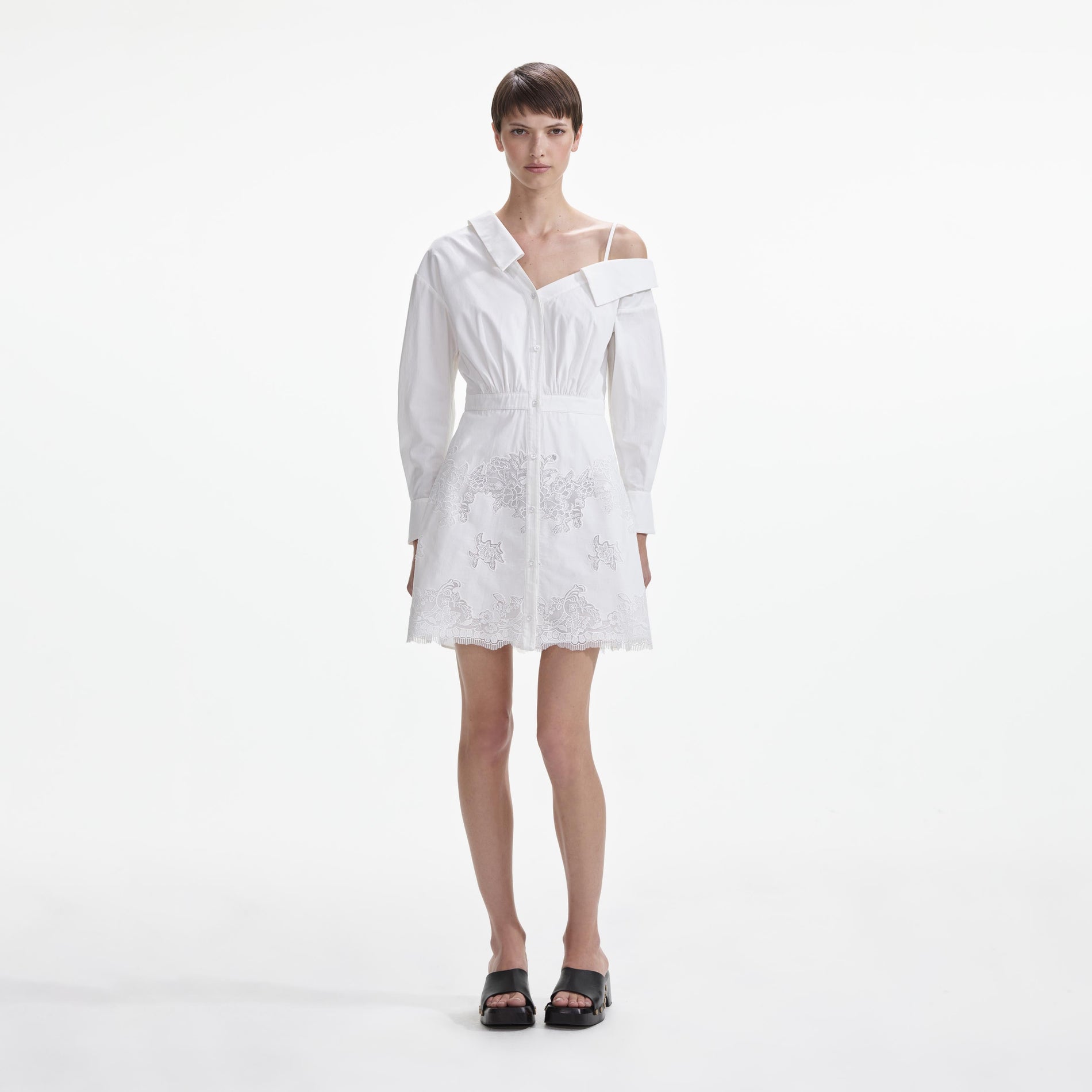 Front view of a woman wearing the White Cotton Lace Hem Mini Dress