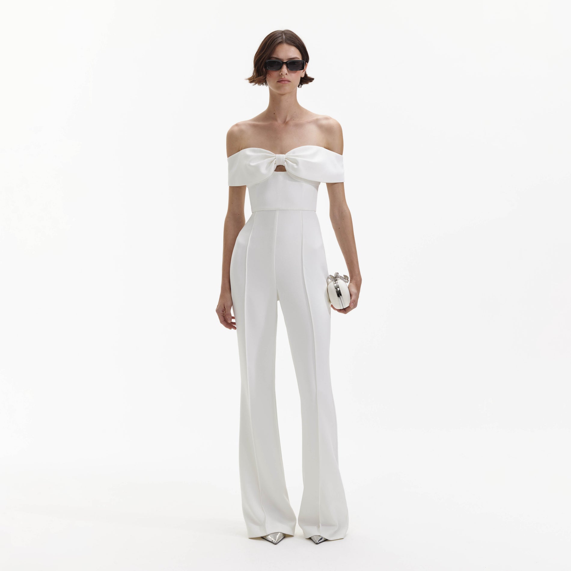 A Woman wearing the White Crepe Bow Jumpsuit