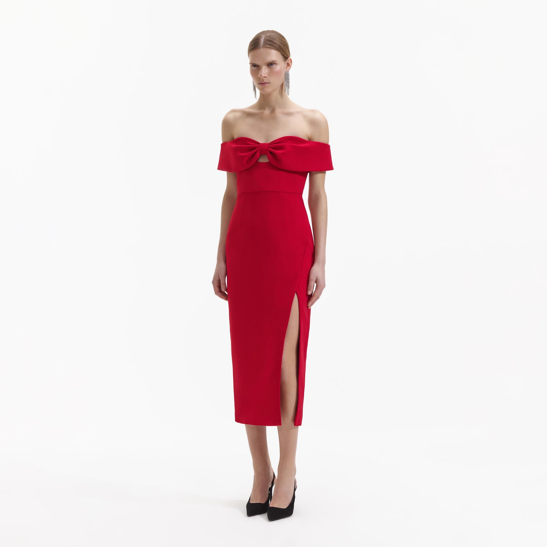 Side view of a woman wearing the Red Crepe Off Shoulder Bow Midi Dress