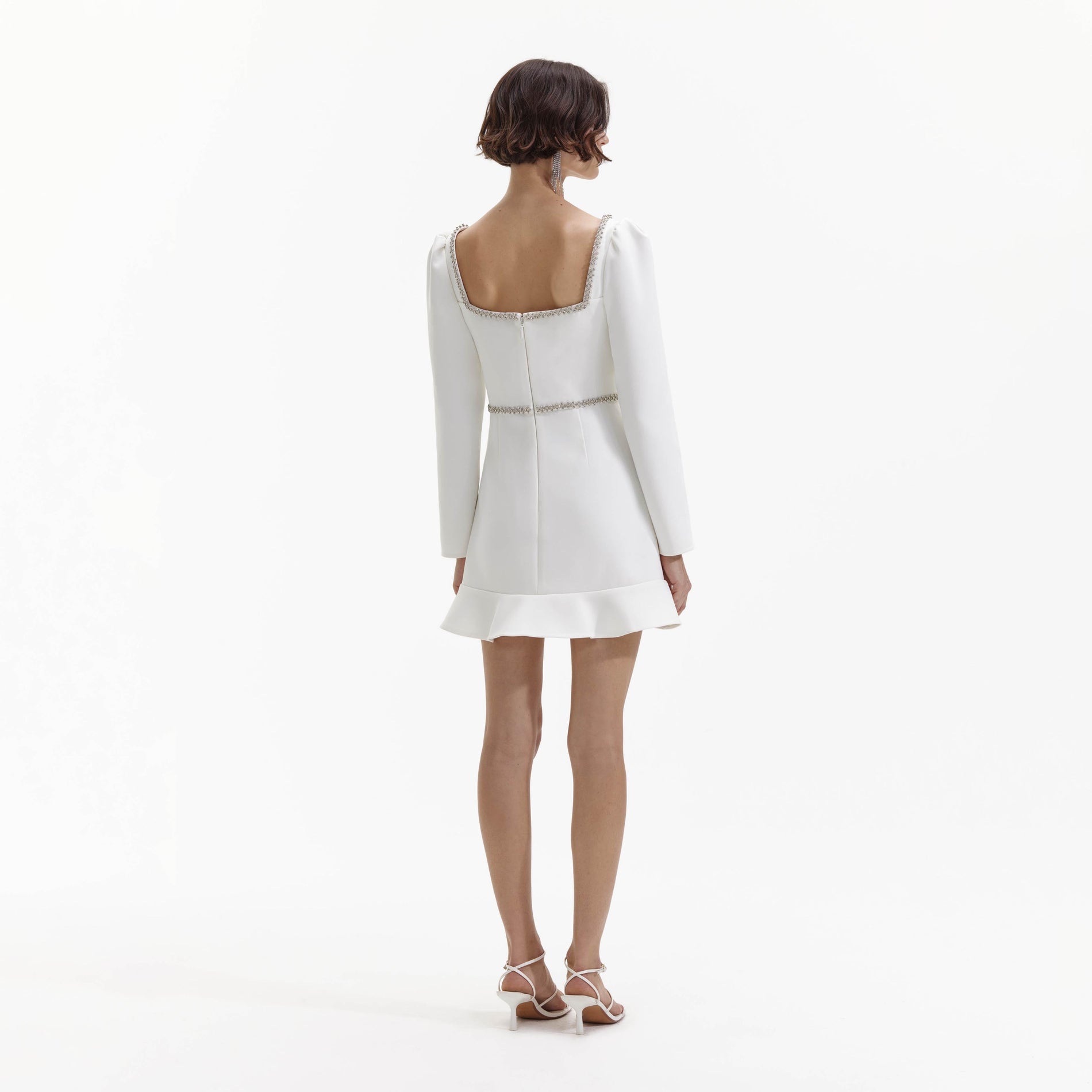 Back view of a woman wearing the White Bonded Crepe Long Sleeve Mini Dress