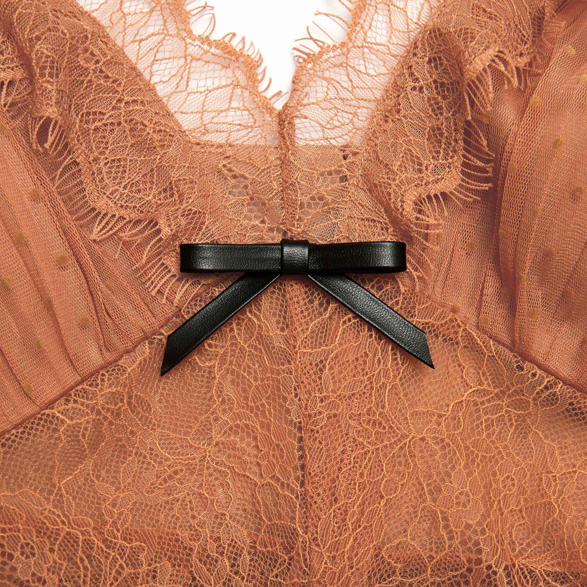 Side view of a woman wearing the Tan Dot Mesh Bodysuit