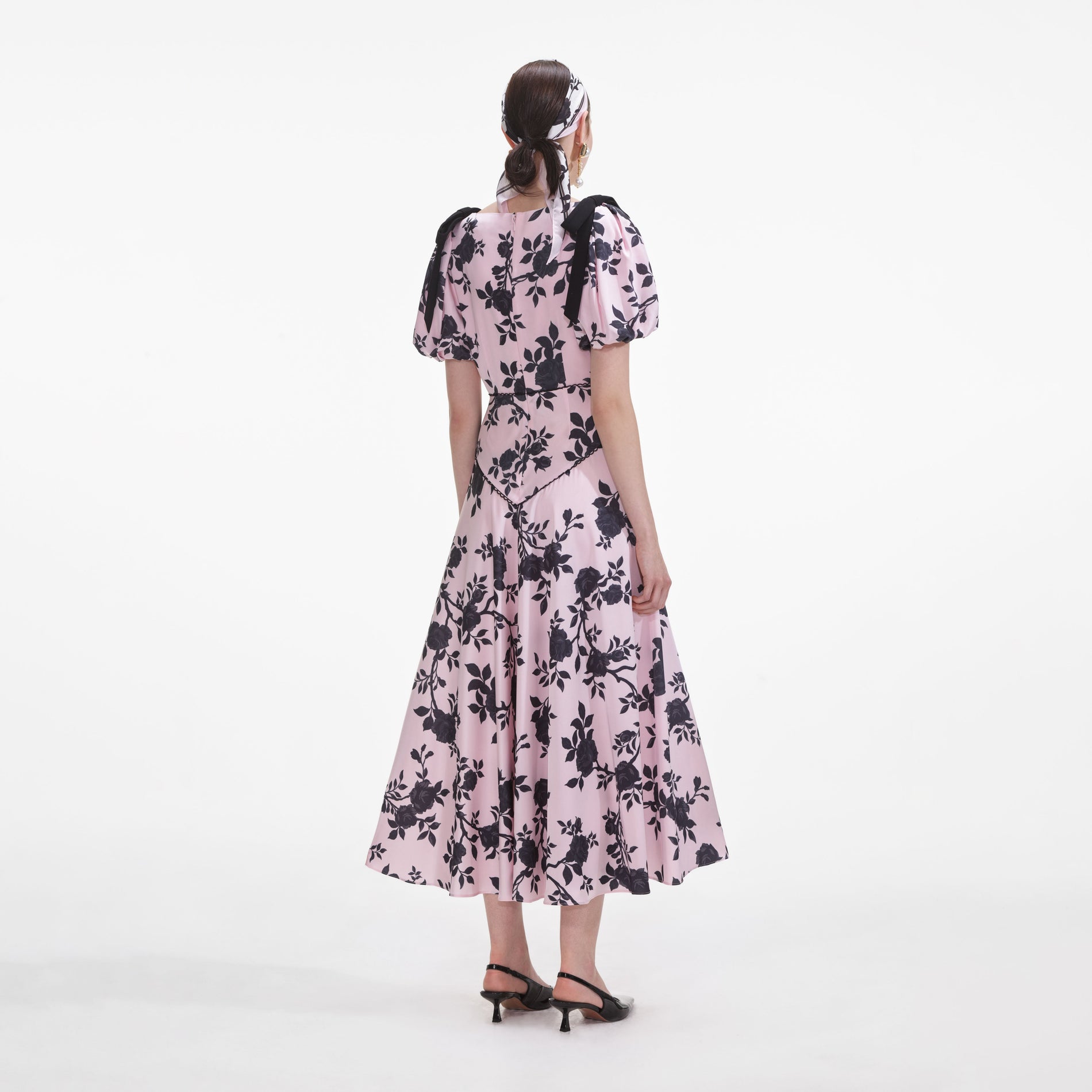 Back view of a woman wearing the Pink Satin Floral Midi Dress