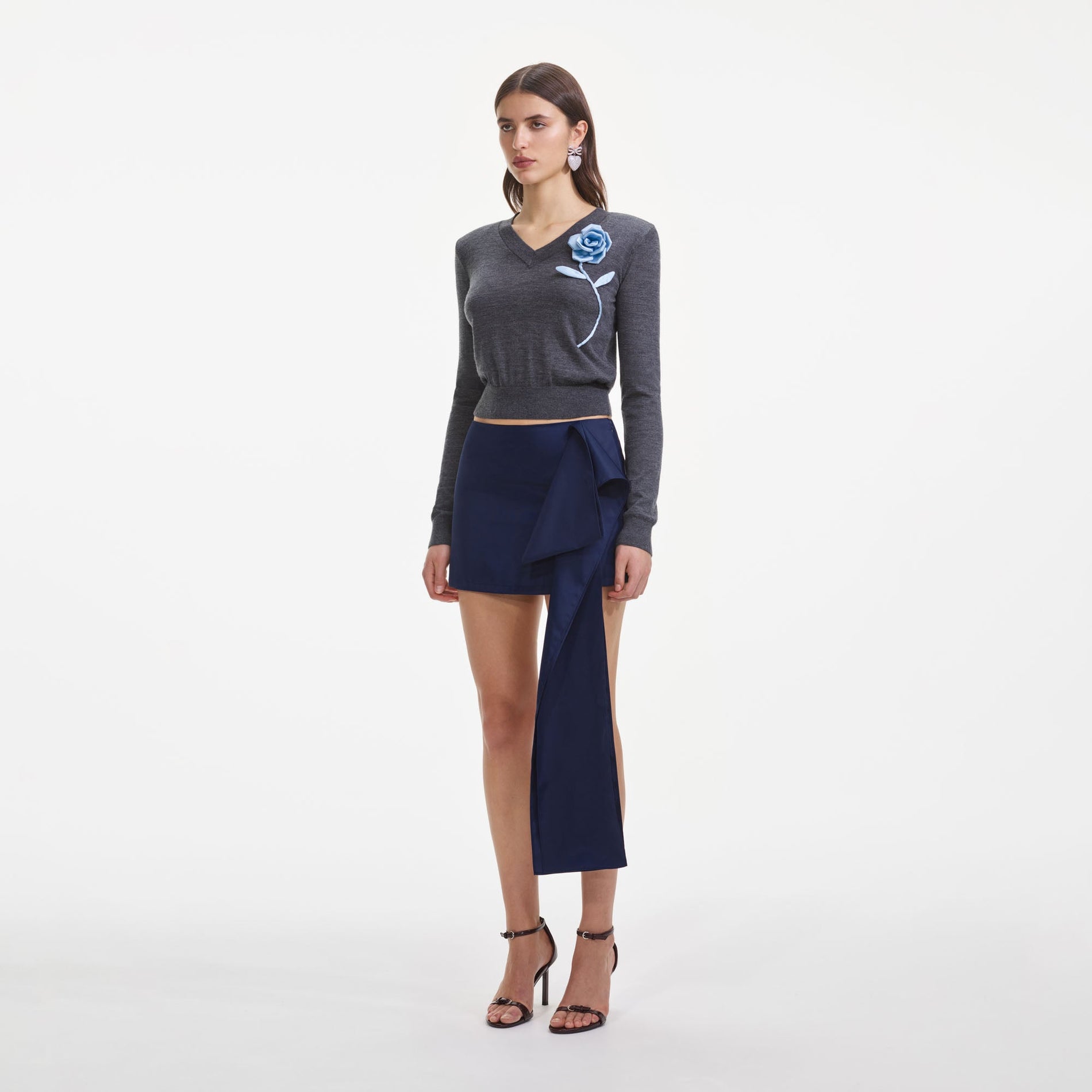 Side view of a woman wearing the Charcoal Blue Rose Lightweight Jumper