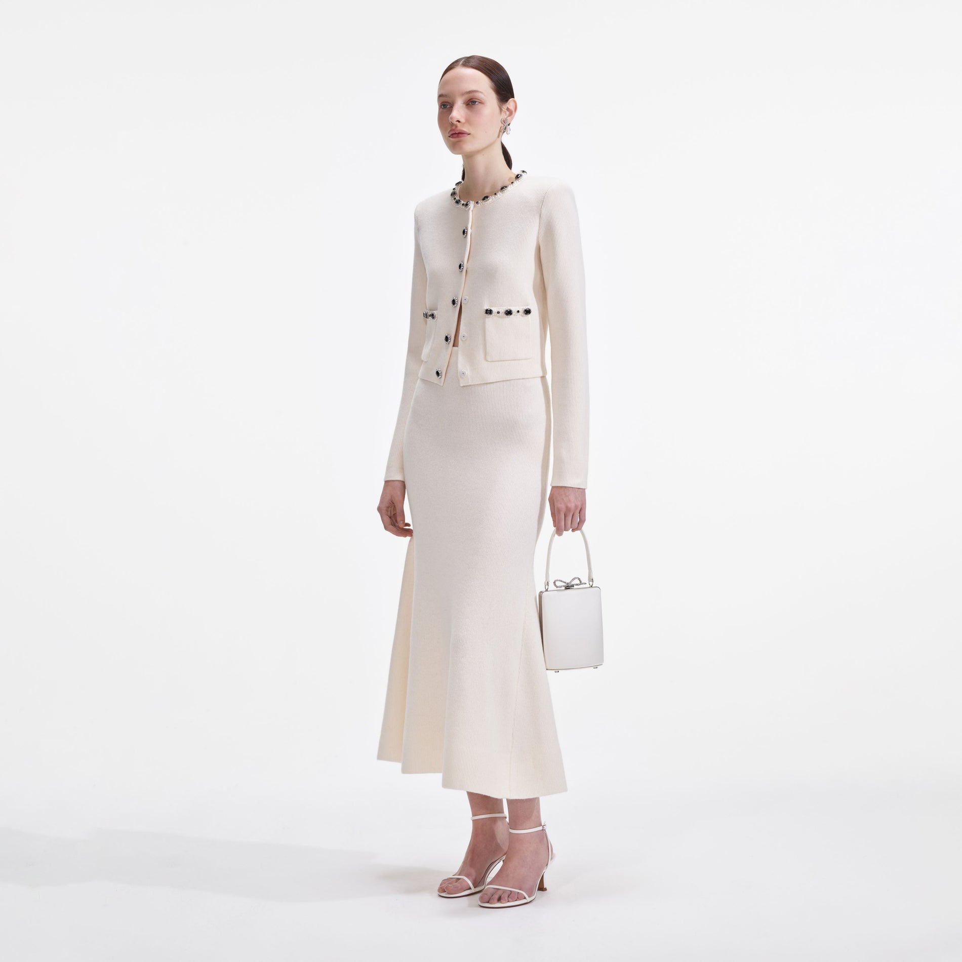 Side view of a woman wearing the Cream Embellished Cardigan