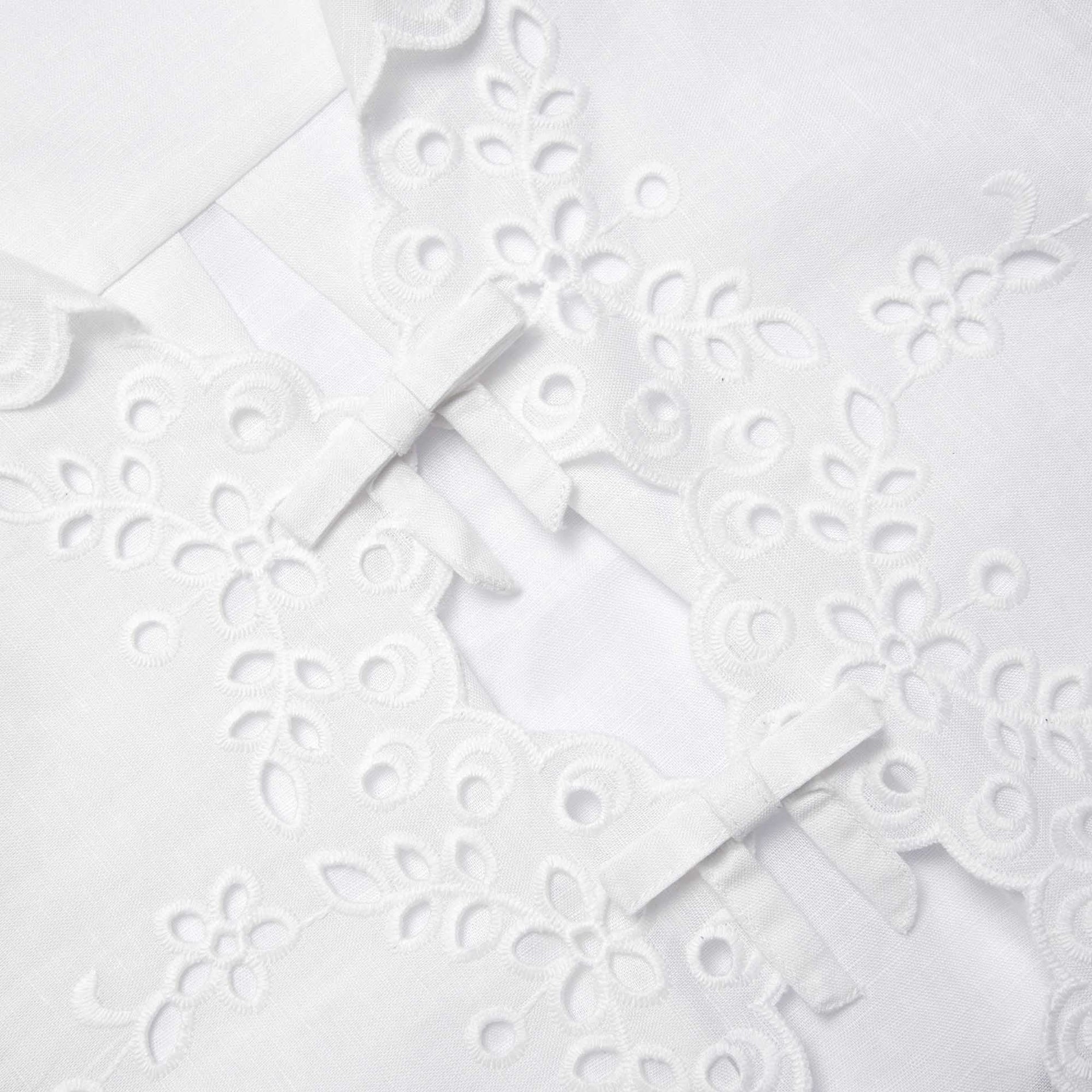 Side view of a woman wearing the Cream Linen Embroidered Trousers