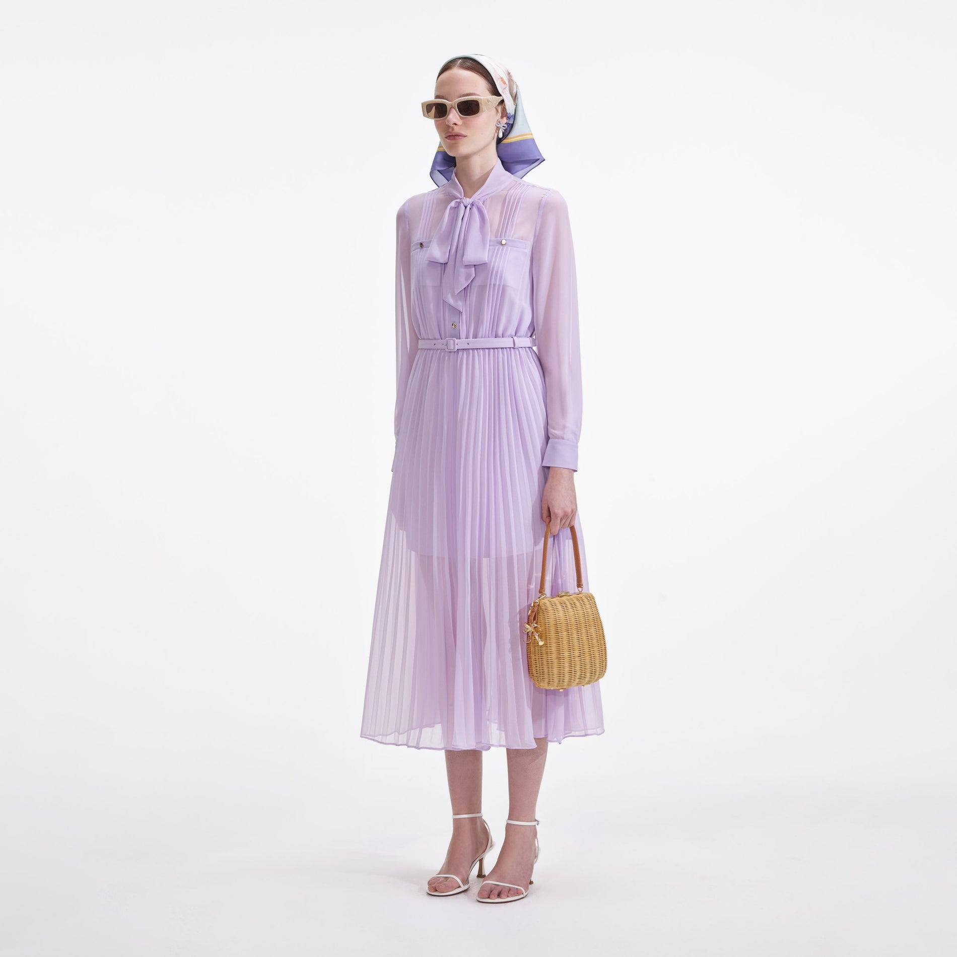 Side view of a woman wearing the Lilac Chiffon Pussy Bow Midi Dress