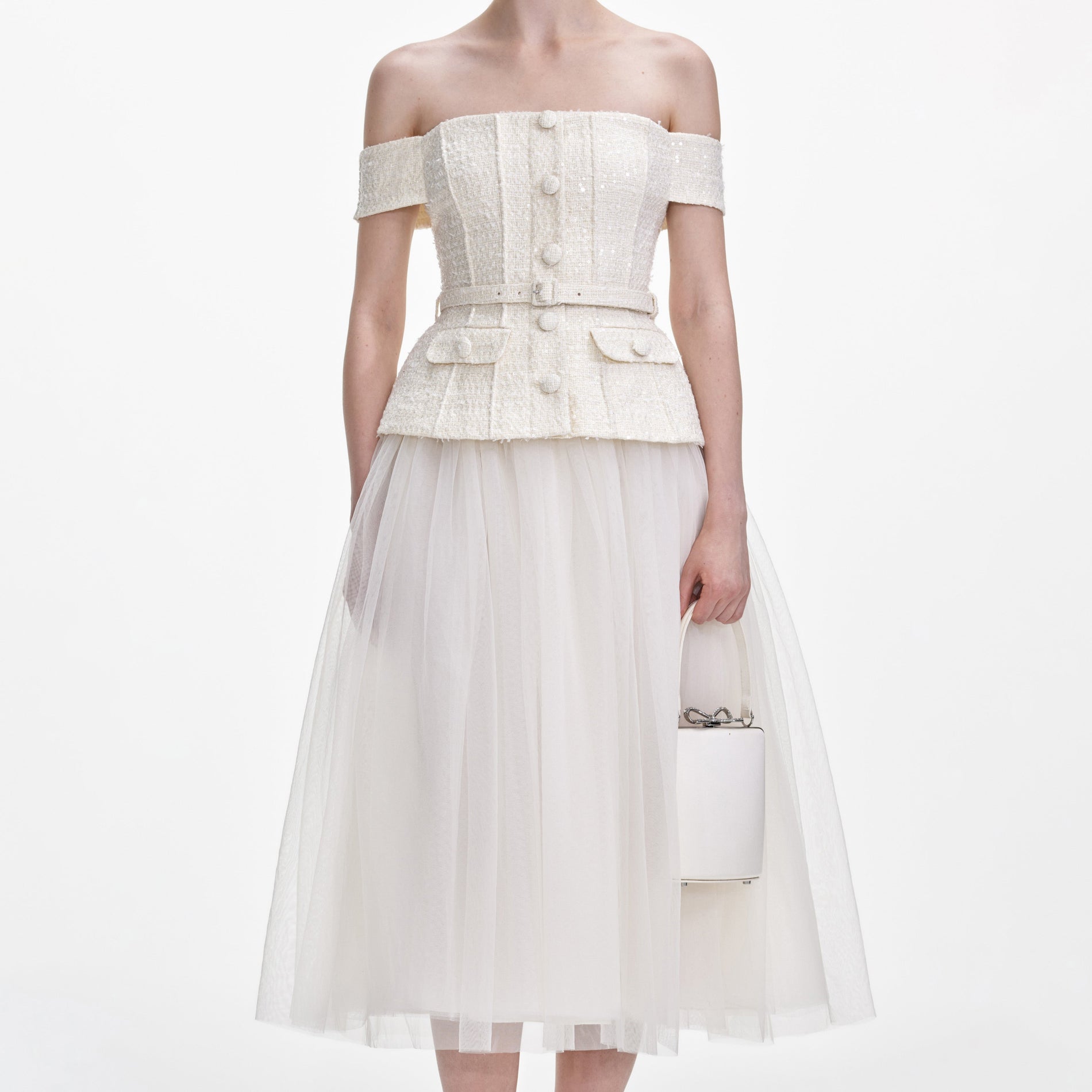 A close up of a woman wearing the Cream Boucle Tulle Midi Dress