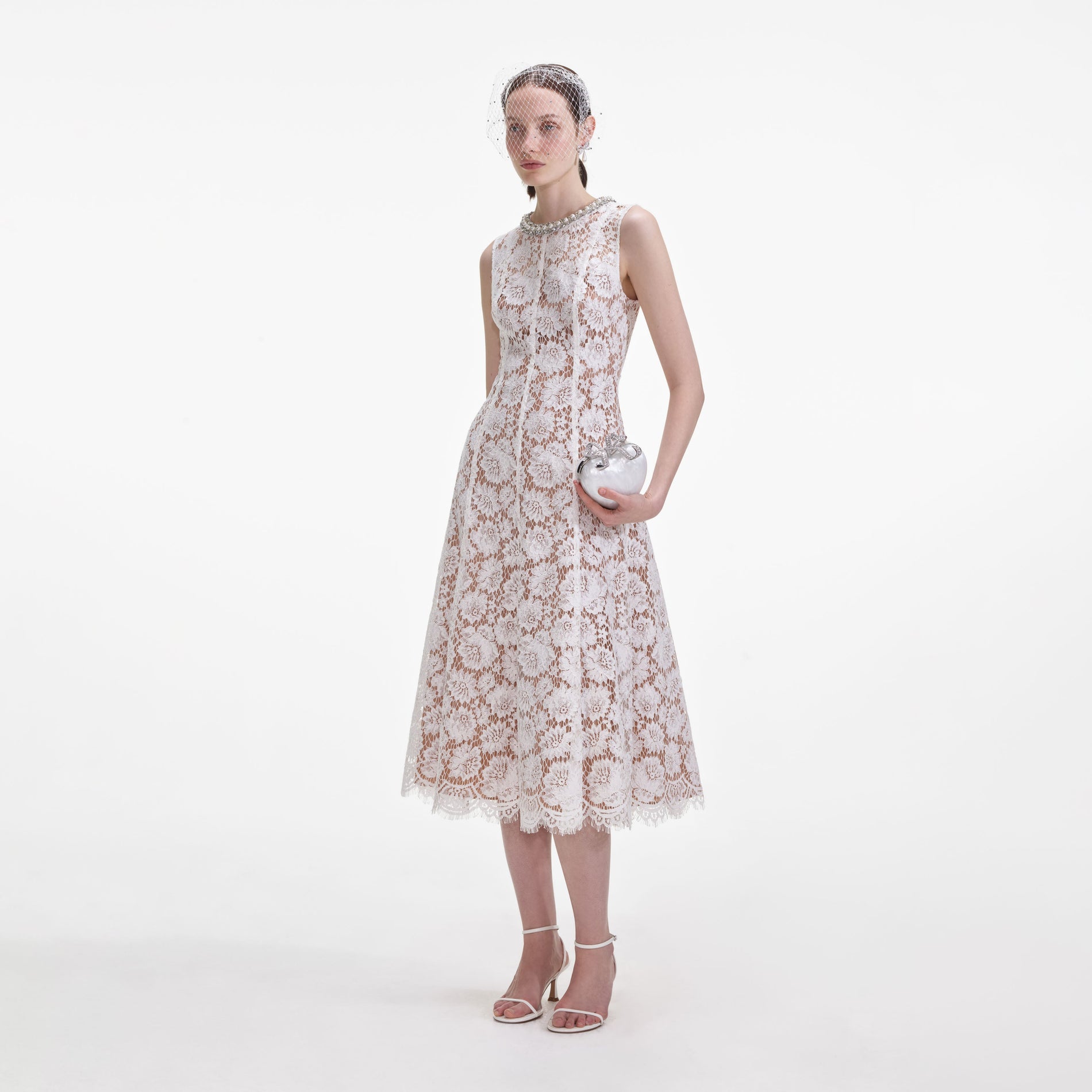 Side view of a woman wearing the White Fine Lace Pearl Midi Dress