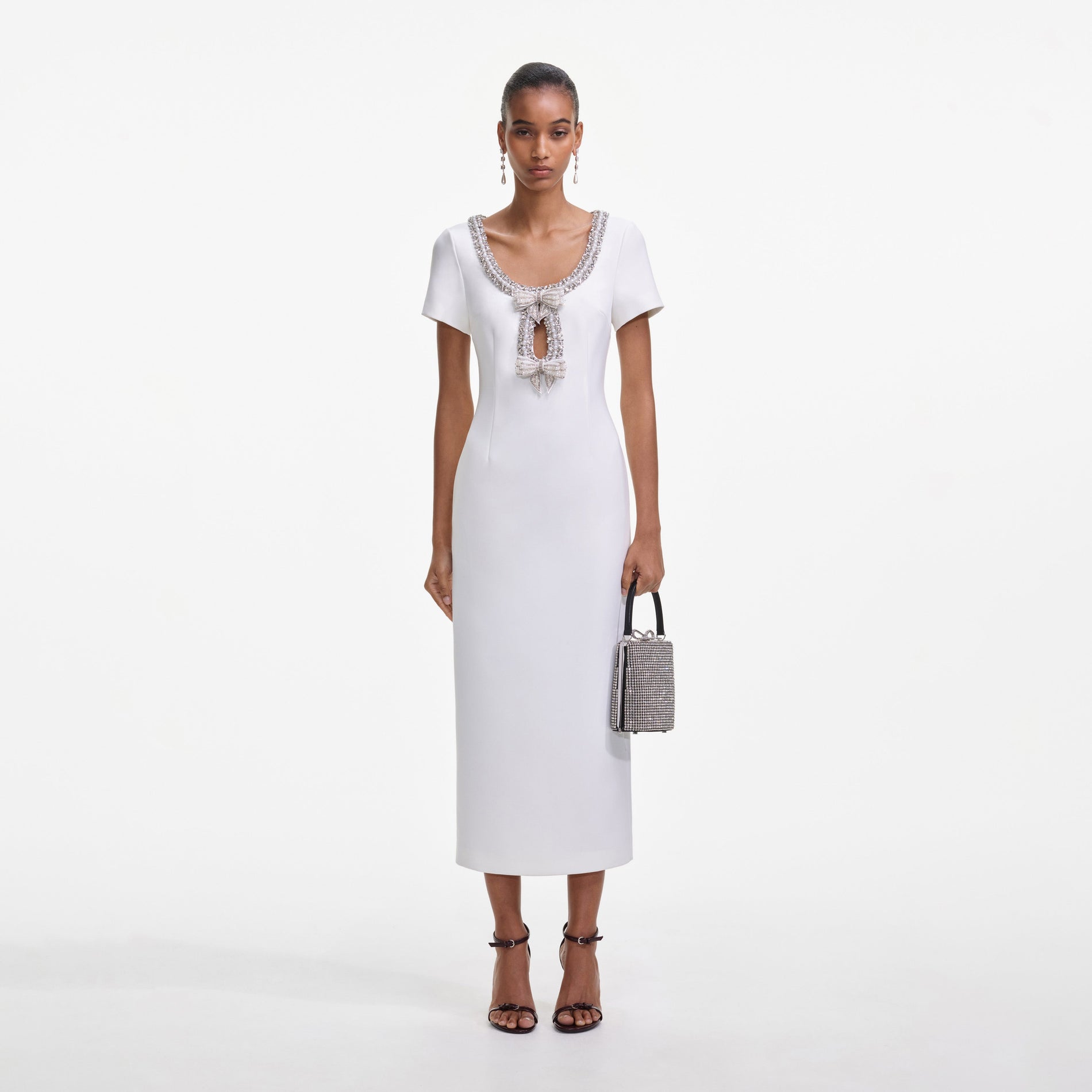 Front view of a woman wearing the White Crepe Bow Midi Dress