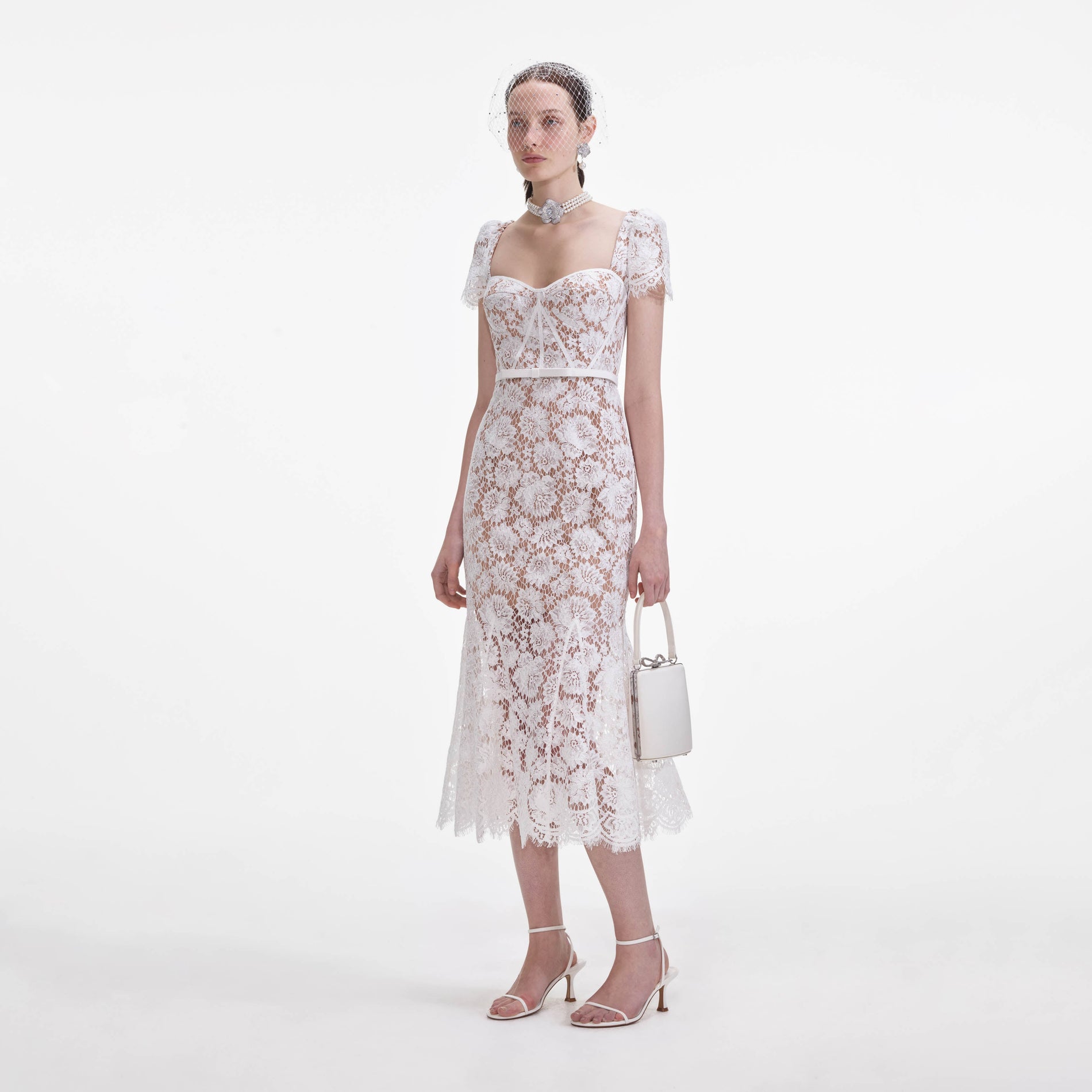 Side view of a woman wearing the White Fine Lace Midi Dress