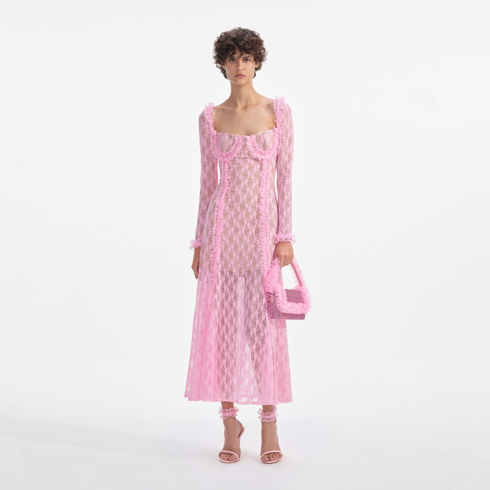 Front view of a woman wearing the Pink Lace Ruffle Midi Dress