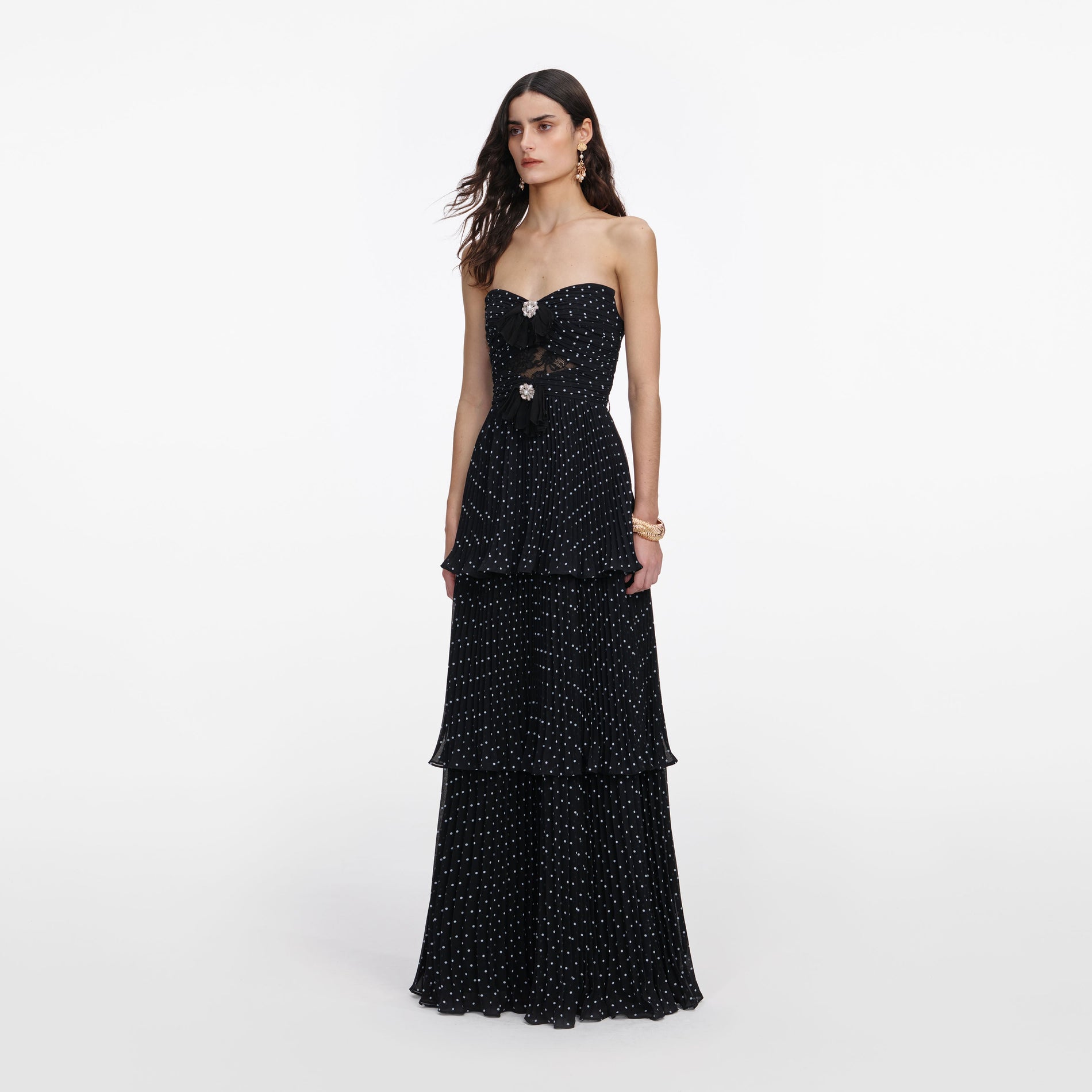 Side view of a woman wearing the Black Polka Dot Tiered Maxi Dress