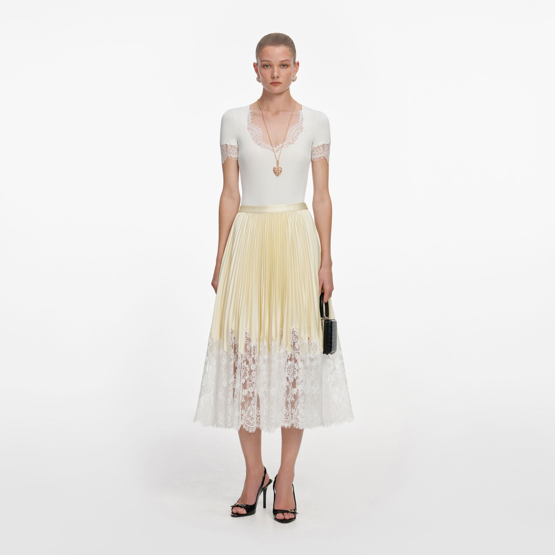 Front view of a woman wearing the Yellow Satin Lace Midi Skirt