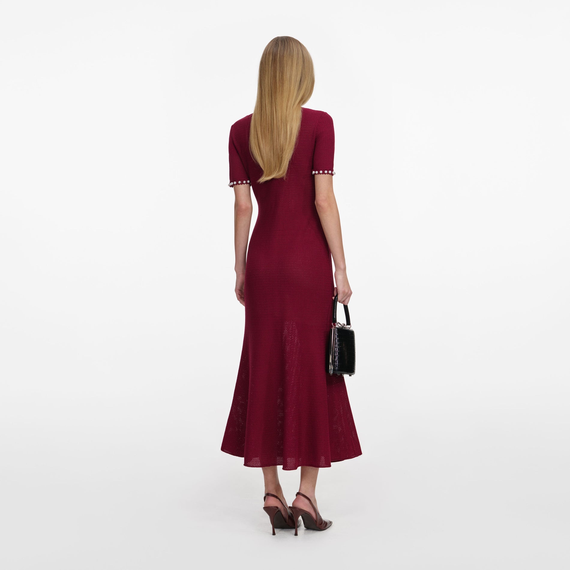 Back view of a woman wearing the Burgundy Pearl Knit Midi Dress