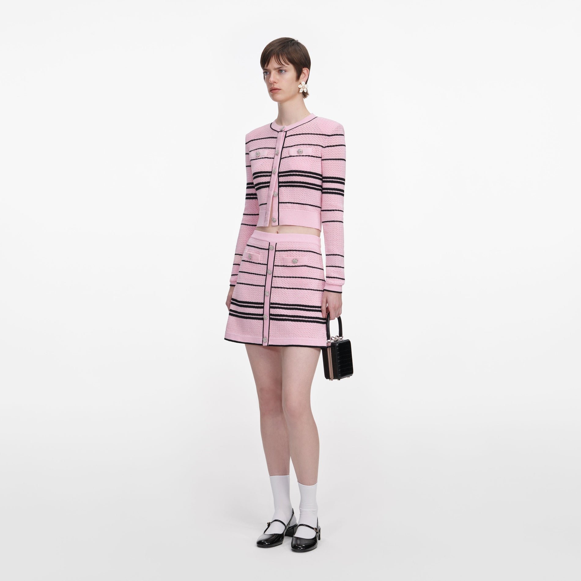 Side view of a woman wearing the Pink Stripe Knit Mini Skirt