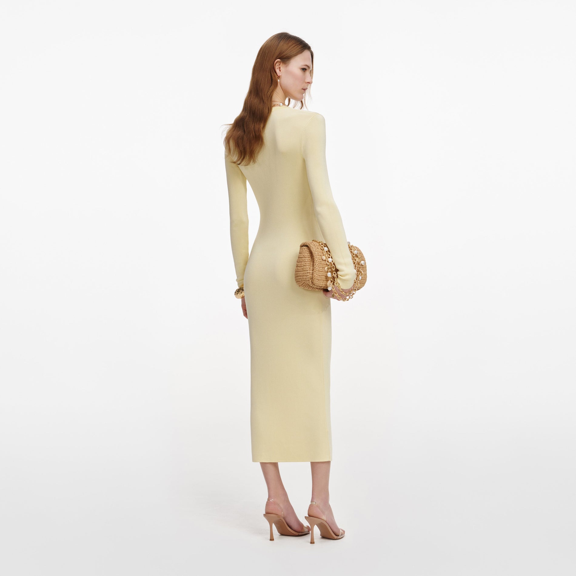 Back view of a woman wearing the Yellow Viscose Knit Ruffle Midi Dress