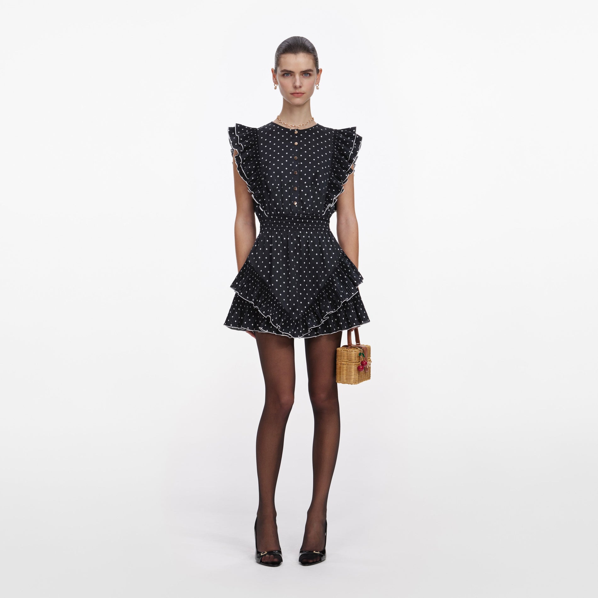 Front view of a woman wearing the Black Polka Dot Frill Mini Dress