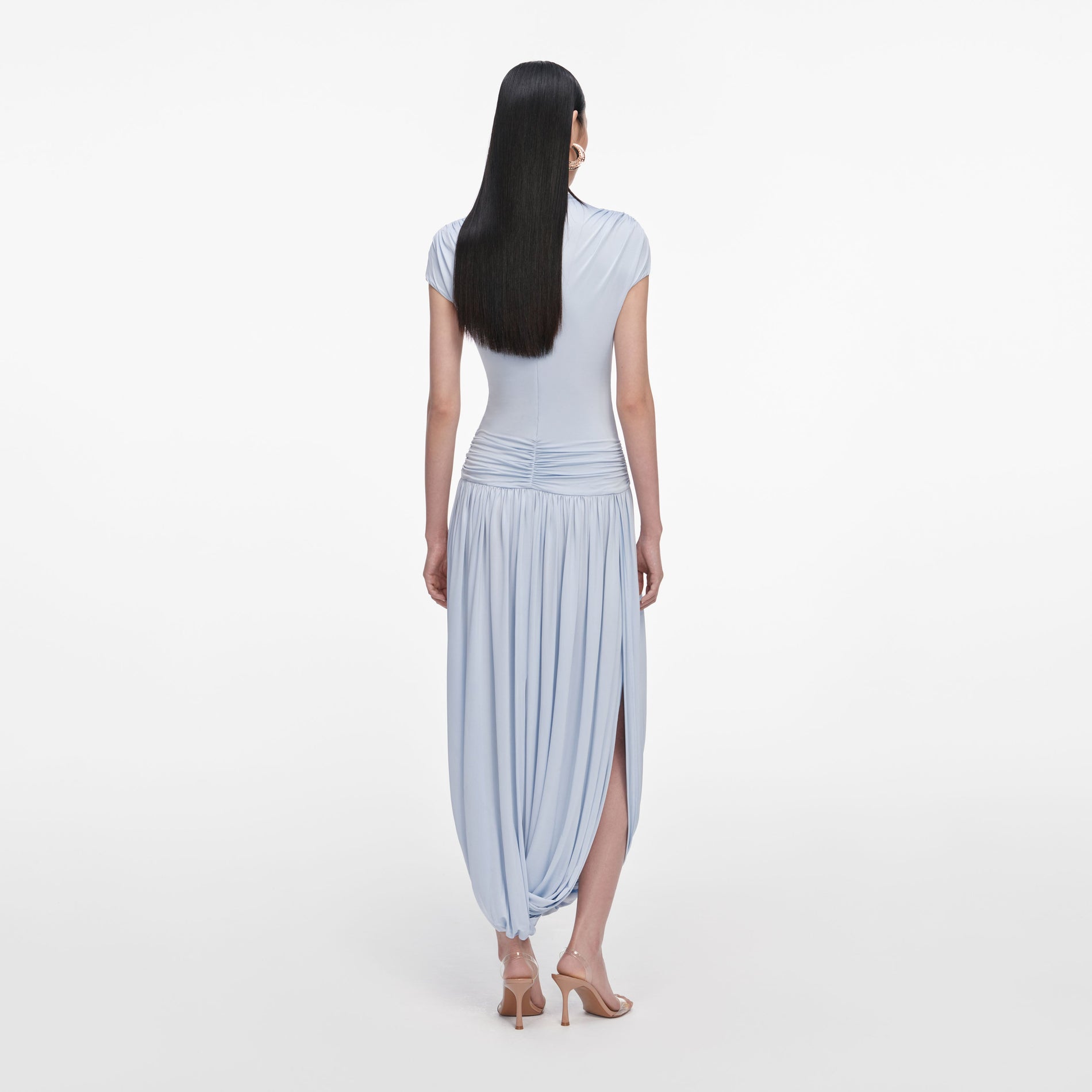 Back view of a woman wearing the Blue Jersey Gathered Midi Dress