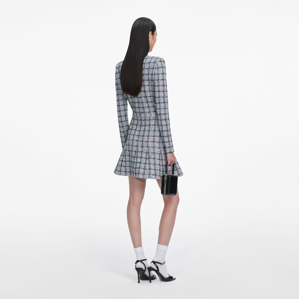 Back view of a woman wearing the Blue Check Knit Mini Skirt