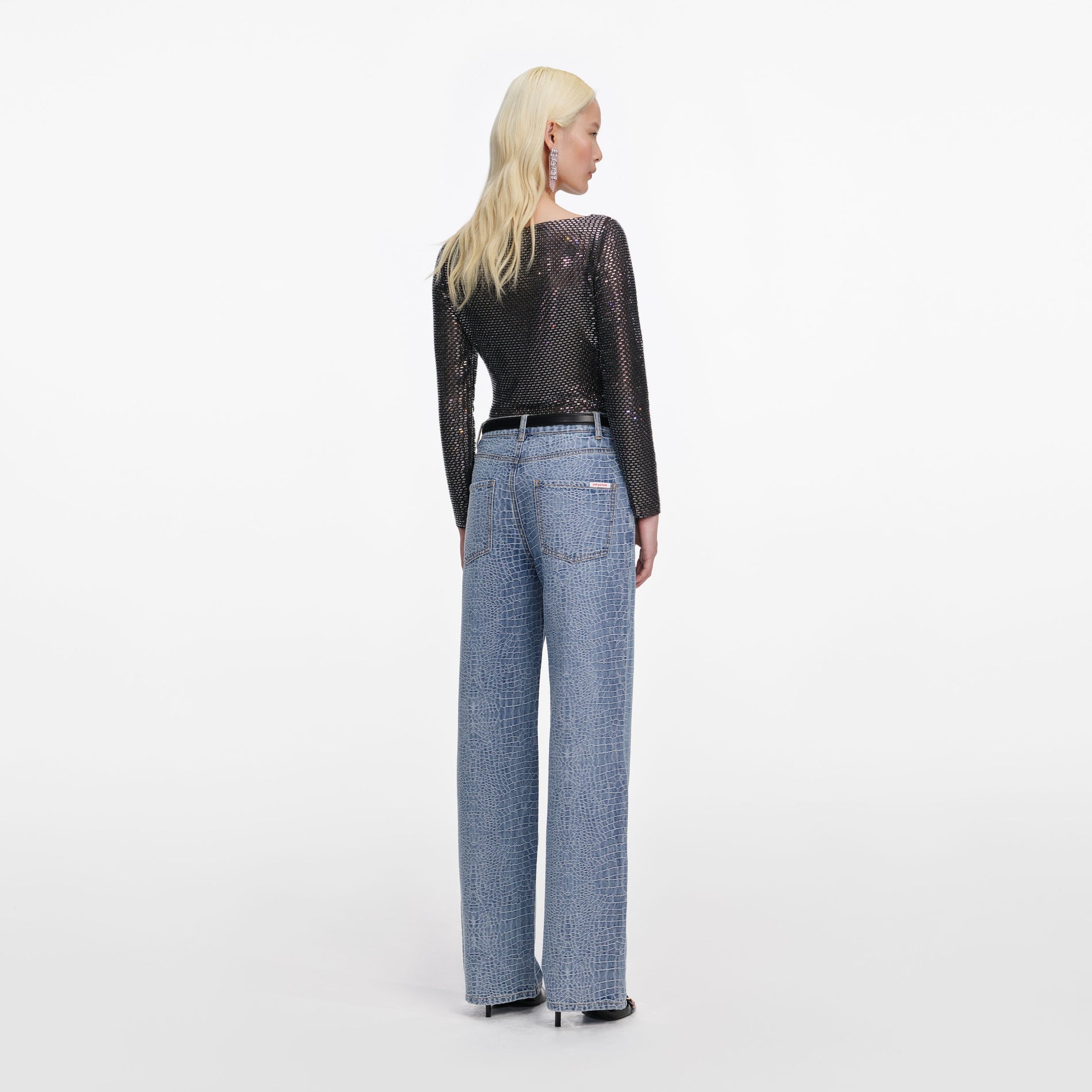 Back view of a woman wearing the Croc Effect Straight Leg Jeans