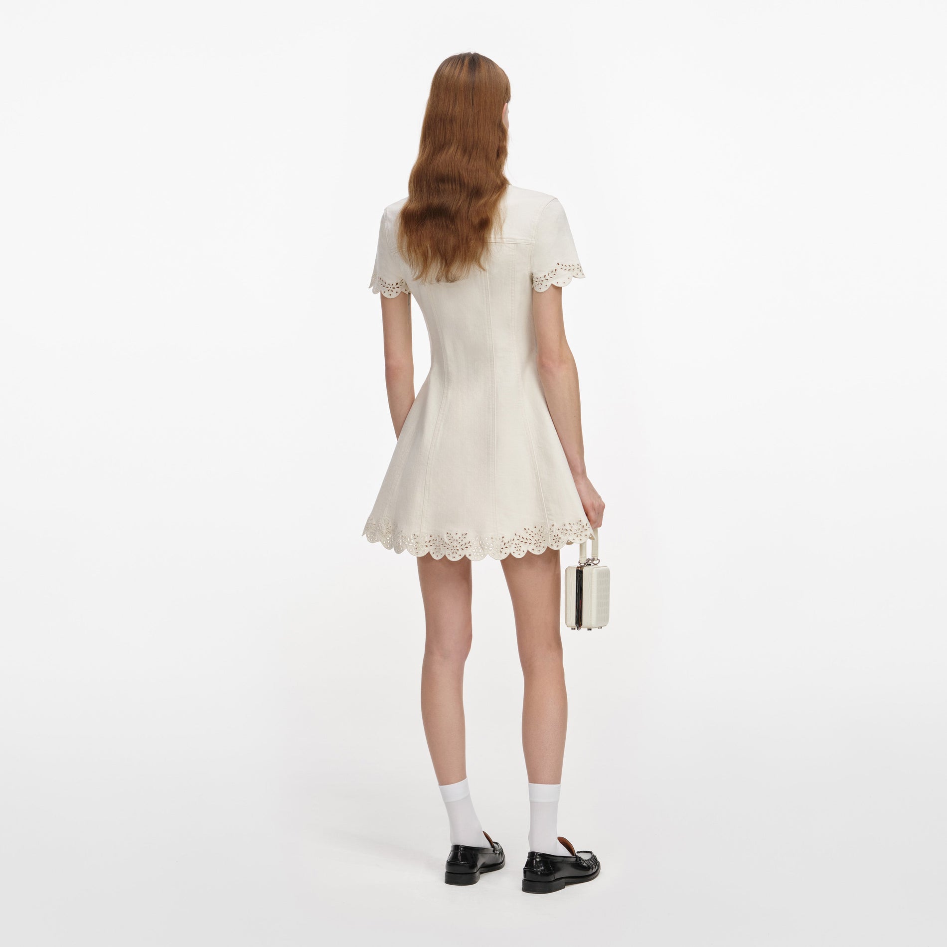 Back view of a woman wearing the Cream Broderie Denim Mini Dress