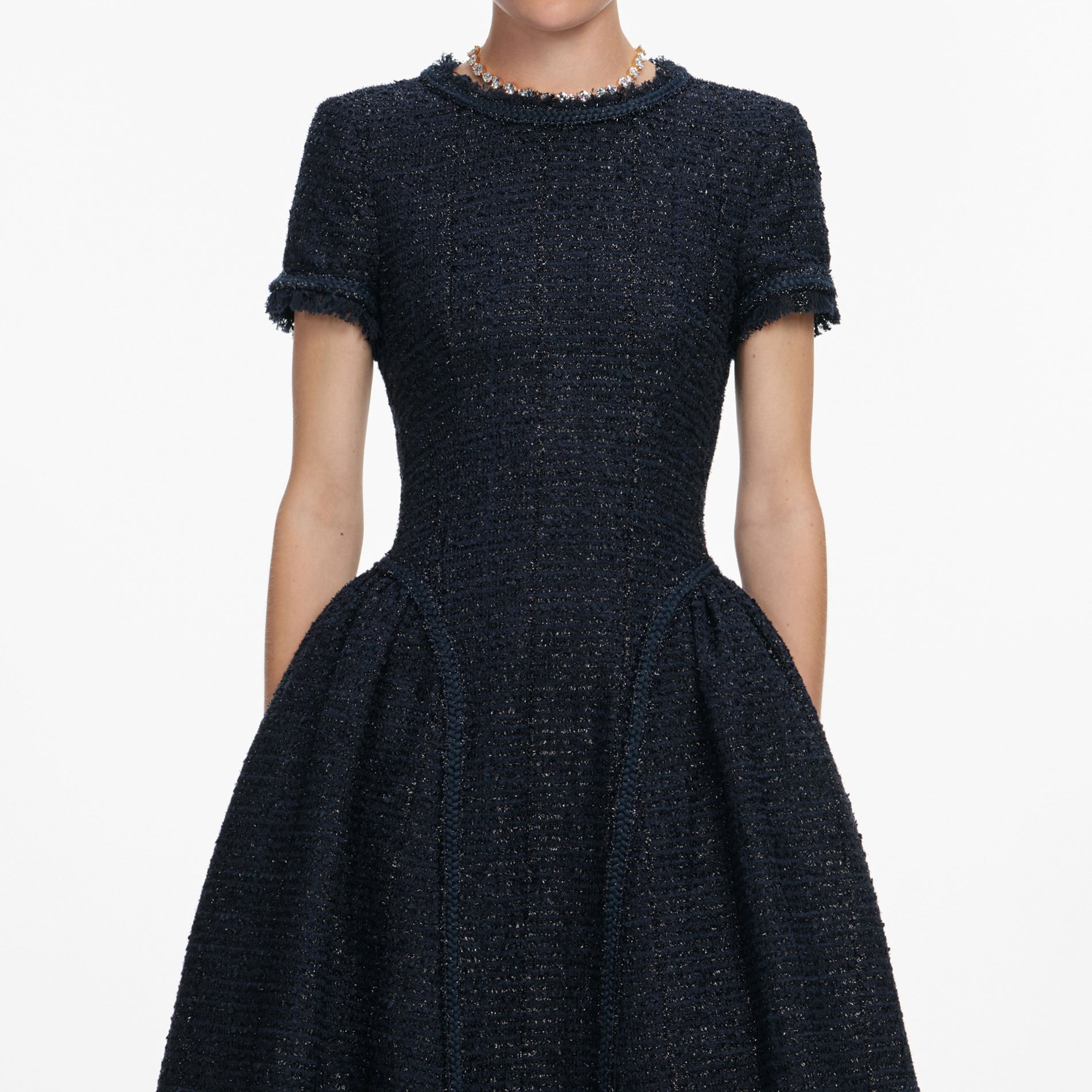 A close up of a woman wearing the Navy Metallic Boucle Midi Dress