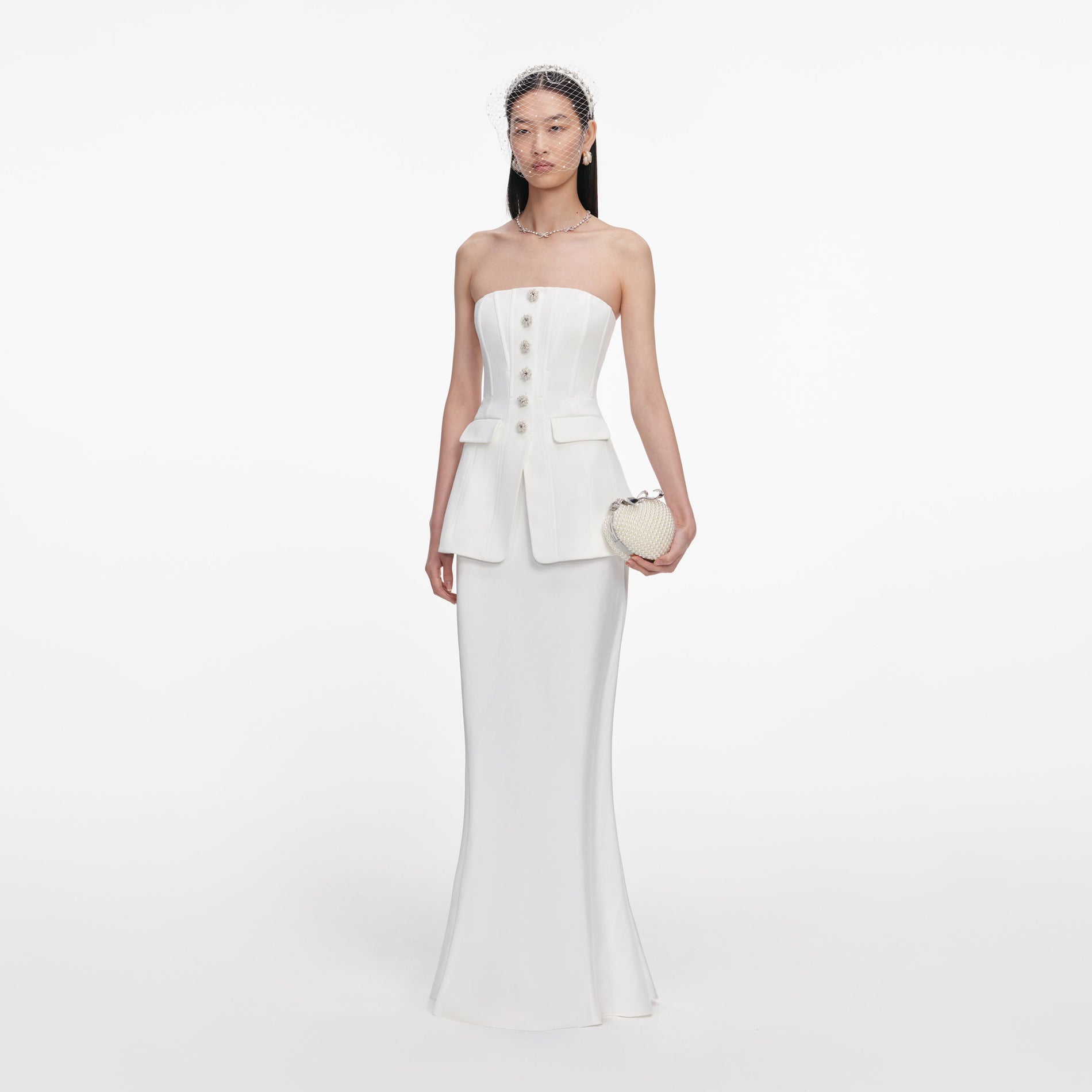 Side view of a woman wearing the White Bandeau Maxi Dress