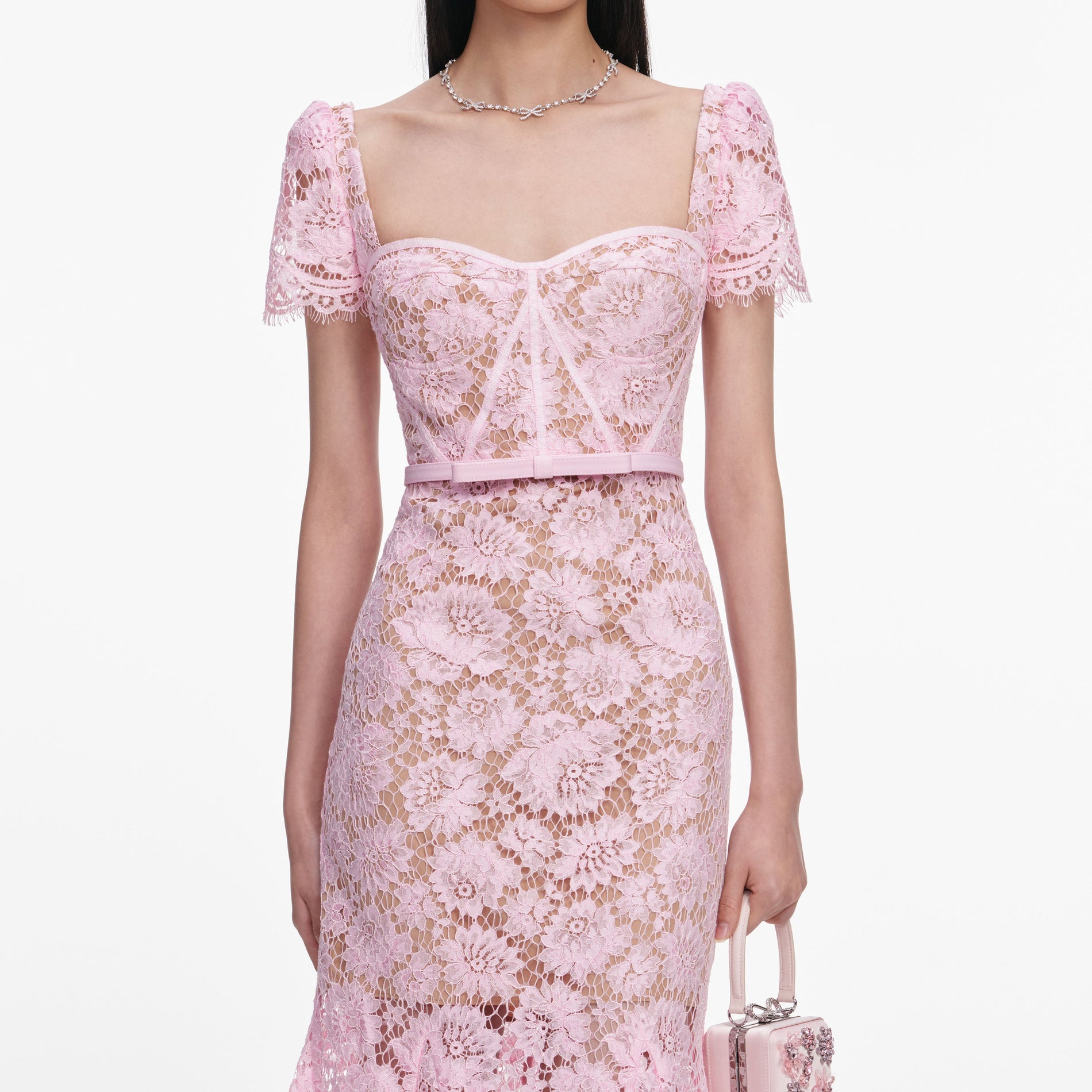 A close up of a woman wearing the Pink Fine Lace Midi Dress