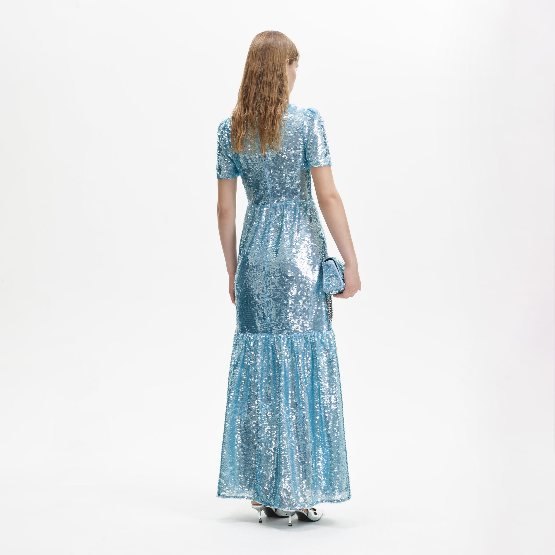 A woman wearing the Blue Sequin Tier Maxi Dress