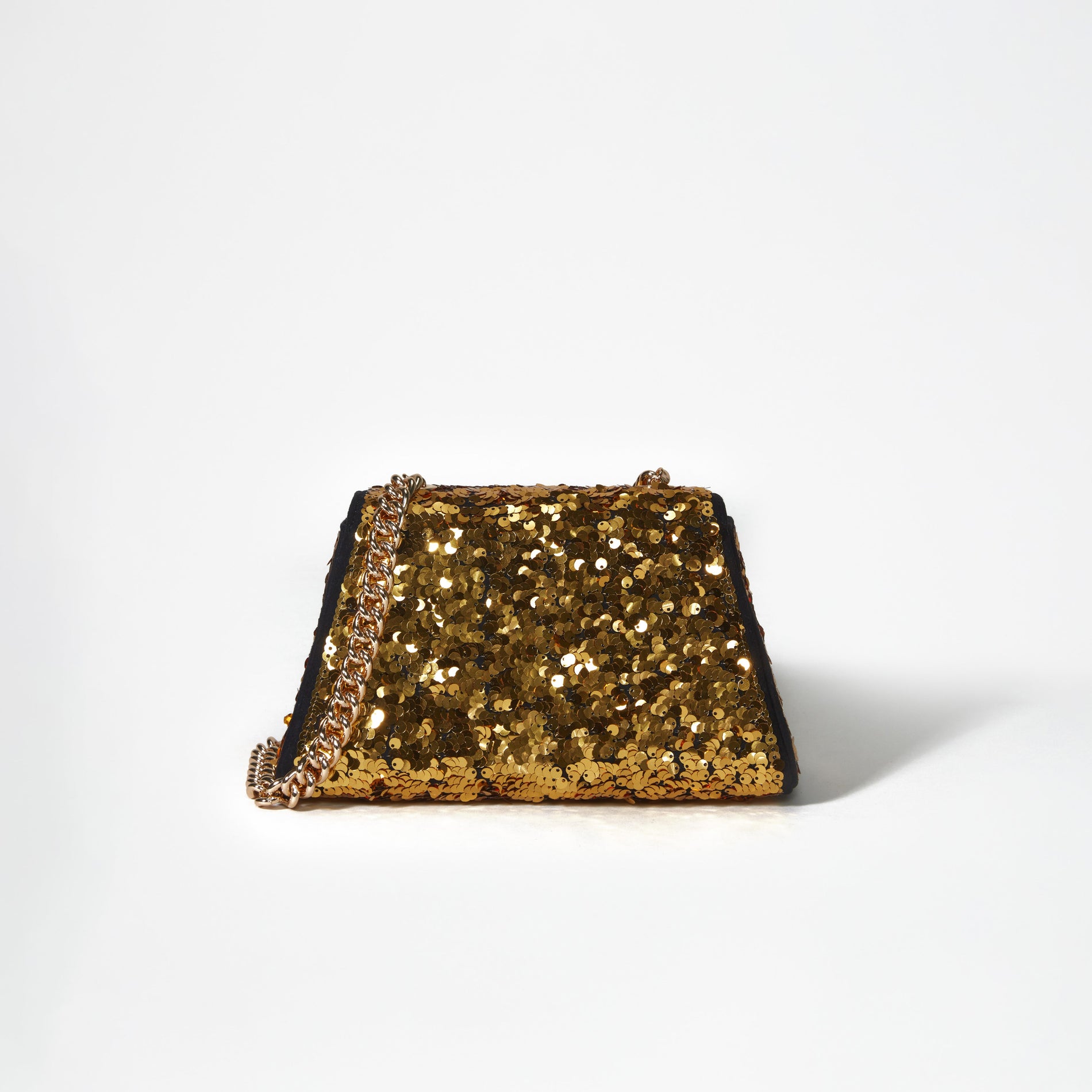 A woman wearing the Gold Sequin Bow Mini Shoulder Bag