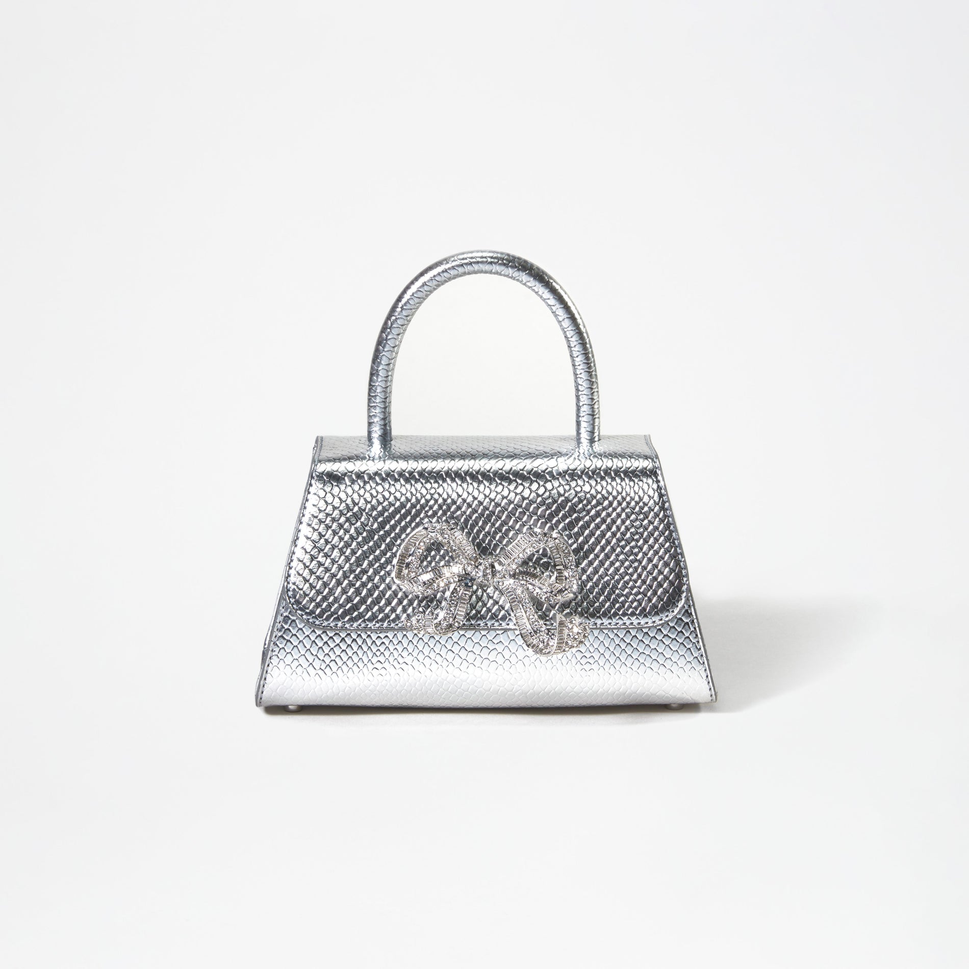 A woman wearing the Silver Python Diamante Bow Mini Bag
