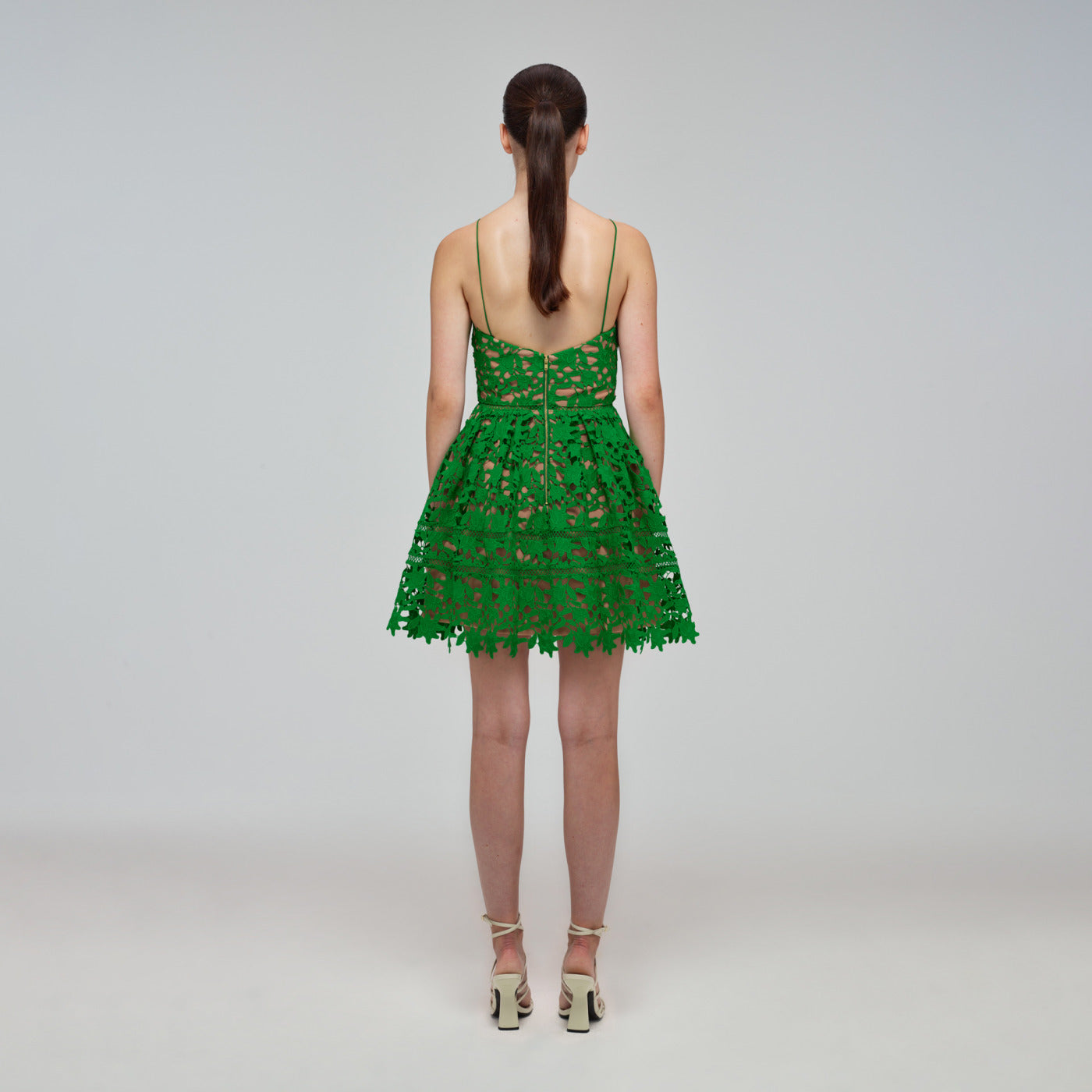 A woman wearing the Deep Green Azaelea Mini Dress